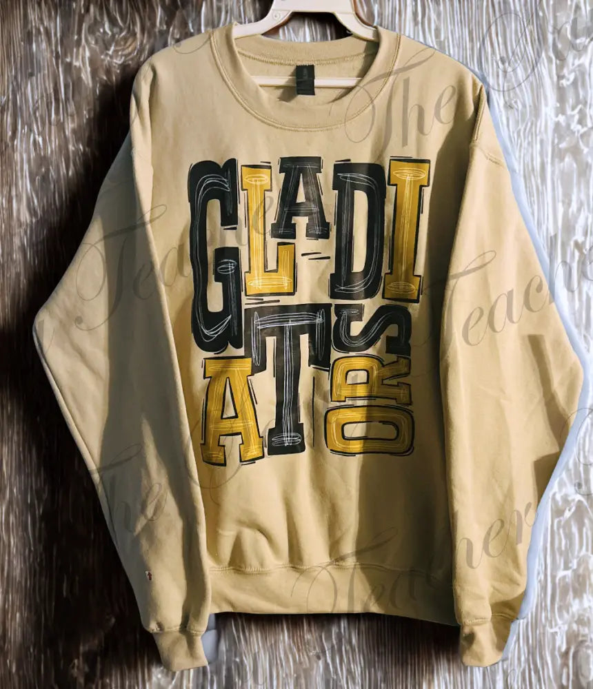 Beige sweatshirt with 'GLADIATOR' text on a wooden surface
