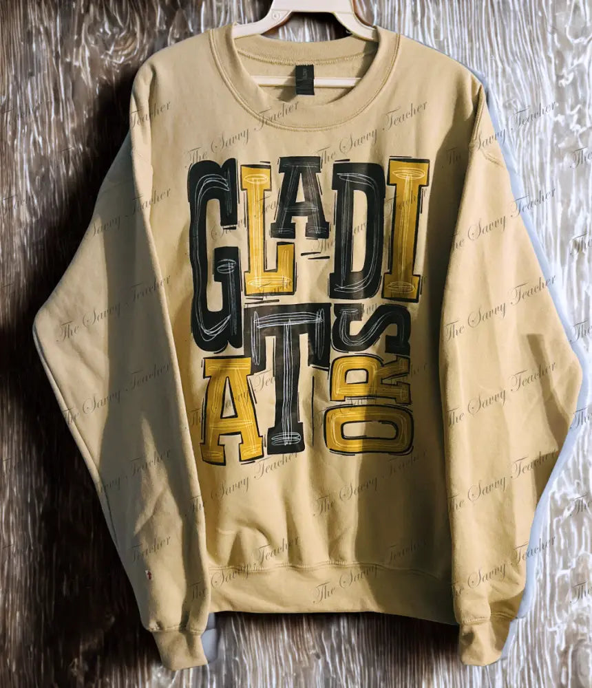 Beige sweatshirt with 'GLADIATOR' text on a wooden surface